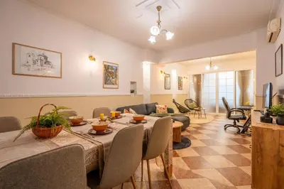 a living room with a table and a couch at Belle Epoque-Sofia-Free parking in Sofia