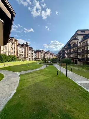 a grassy area in a city with apartment buildings at Daniel's Suite - 4 Season apartment in Bansko