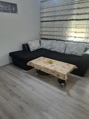 a living room with a couch and a coffee table at Удобство - 2 in Petrich