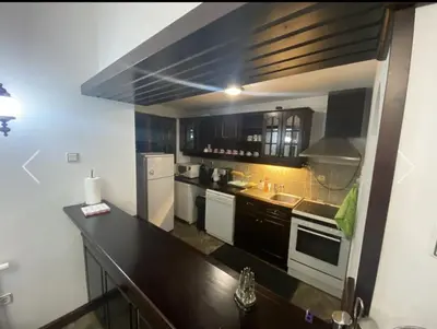 a kitchen with a black counter top in a room at Вила СевРич in Sarnitsa