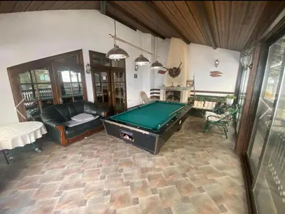 a living room with a pool table in it at Вила СевРич in Sarnitsa