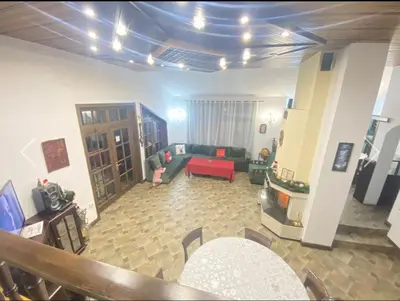 a living room with a couch and a red sofa at Вила СевРич in Sarnitsa