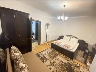 a living room with a bed and a dresser at Вила СевРич in Sarnitsa