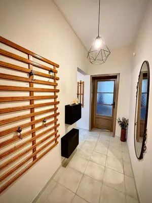 a hallway with a wooden partition with a door at просторен и уютен двустаен в Долен Лозенец - кварталът на артистите in Sofia