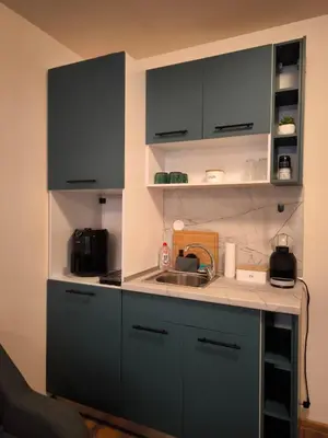 a kitchen with blue cabinets and a sink at NiSimo Apartment Grand Resort Pamporovo in Pamporovo