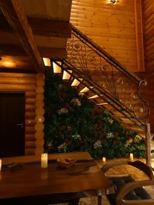 a staircase with a table and a green wall at Стилни и Луксозни Вили за разпускане in Malo Buchino