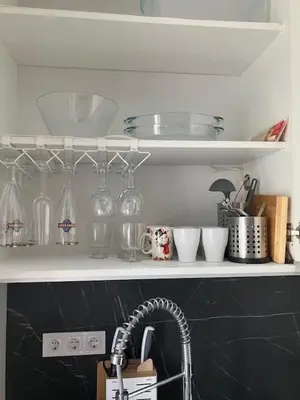 a kitchen with a sink and some glasses on a shelf at Ira 28 in Sandanski