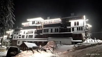 a large building with snow in front of it at night at Grand Studio A1 in Pamporovo