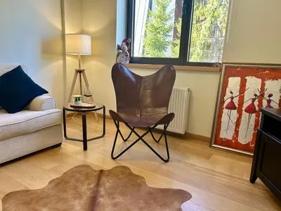 a living room with a chair and a couch at Beauty&Travel Apartment Borovets in Borovets