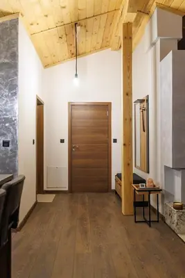 a hallway with a wooden door and a table at Mountain studio Govedartsi in Govedartsi