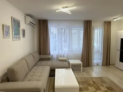 a living room with a couch and a table at White Pearl Apartment - Top Location, Bright & Spacious, Newly Renovated in Sofia