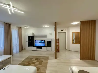 a large living room with a tv and a couch at White Pearl Apartment - Top Location, Bright & Spacious, Newly Renovated in Sofia