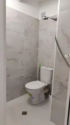 a bathroom with a white toilet in a room at White Pearl Apartment - Top Location, Bright & Spacious, Newly Renovated in Sofia