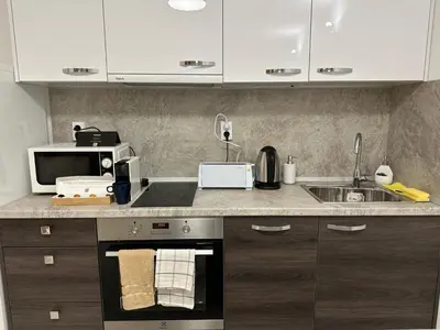a kitchen with a stove and a microwave at White Pearl Apartment - Top Location, Bright & Spacious, Newly Renovated in Sofia