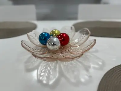 a glass bowl with colorful balls in it on a table at White Pearl Apartment - Top Location, Bright & Spacious, Newly Renovated in Sofia