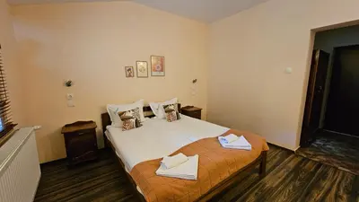 a bedroom with a bed with two towels on it at Hotel Izvorat Arda - Хотел Изворът Арда in Arda