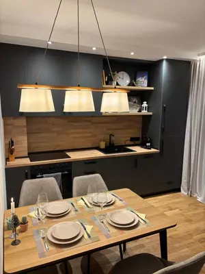 a dining room with a table and a kitchen at Ski-in Flat Next to Ski Road at Mountain View in Bansko