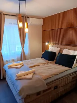 a bedroom with a large bed with towels on it at Double to bul Tsar Boris 3 in Sofia