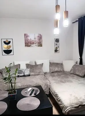 a living room with a couch and a table at Double to bul Tsar Boris 3 in Sofia