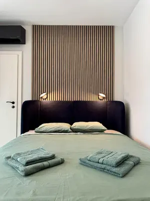 a bed with two towels on top of it at Eleve Residences Sofia in Sofia