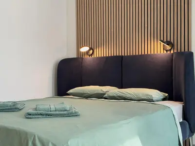 a bed with two pillows and two towels on it at Eleve Residences Sofia in Sofia