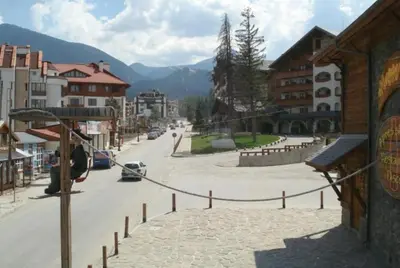 a view of a street in a town with buildings at Granat next to Ski Lift by BookVillaBG in Bansko