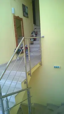 a staircase in a room with a metal railing at Motel Elegance in Sandanski