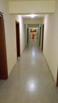 an empty hallway of a building with a long corridor at Motel Elegance in Sandanski