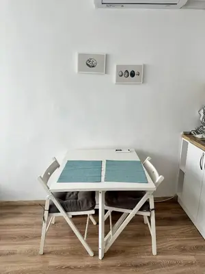 a white table with two chairs in a kitchen at Maria Luiza 1 Bedroom Apartment in Sofia