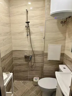 a bathroom with a shower with a toilet and a sink at Maria Luiza 1 Bedroom Apartment in Sofia