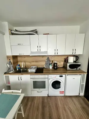 a kitchen with white cabinets and a microwave at Maria Luiza 1 Bedroom Apartment in Sofia