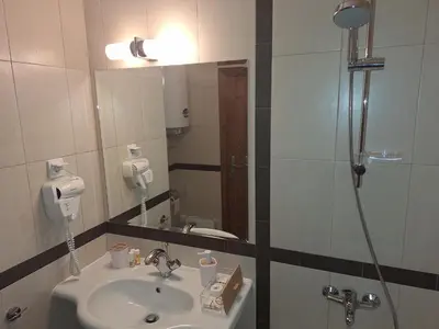 a bathroom with a sink and a shower at Rila Park ap by the Slopes in Borovets