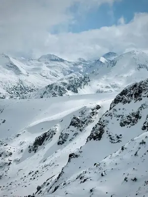 a snowy mountain range with snow covered mountains at Lagom Apartment - Next to the Gondola in Bansko