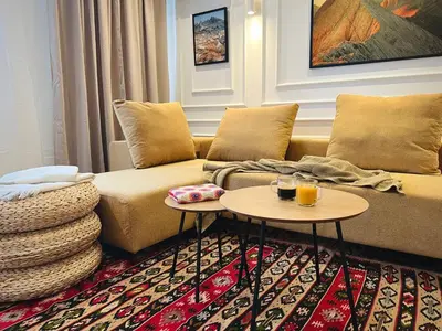 a living room with a couch and two tables at Lagom Apartment - Next to the Gondola in Bansko