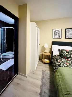 a bedroom with a bed and a bathroom with a tub at Lagom Apartment - Next to the Gondola in Bansko