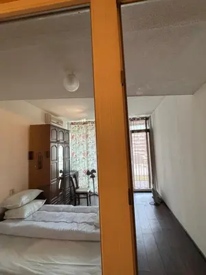 a bedroom with two beds and a dining room at Ritz in Sofia