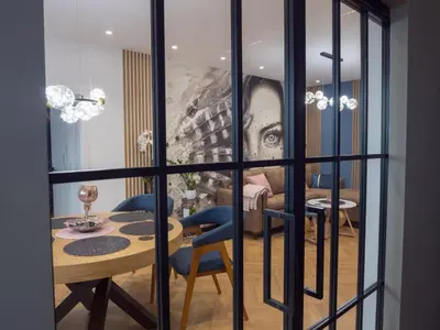 a dining room with a table and a painting of a woman at Blue Iris, 2BR, Stunning Views, Jacuzzi and Workspace in Sofia