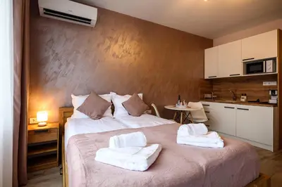 a bedroom with a large bed with towels on it at DreamAparts in Velingrad