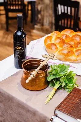 a bottle of wine and bread on a table at Vintage H&R St Anna in Sofia
