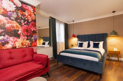 a bedroom with a bed and a red couch at Lambrina 2 Apartment in Plovdiv