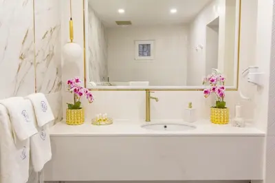 a white bathroom with a sink and a mirror at Lambrina 2 Apartment in Plovdiv