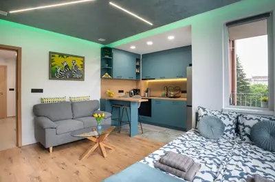 a living room with a couch and a kitchen at Studio Sapphire in Sofia