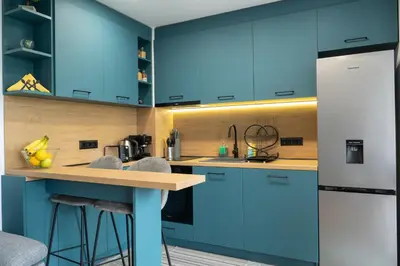 a kitchen with blue cabinets and a counter at Studio Sapphire in Sofia