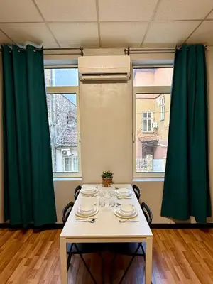 a table in a room with green curtains at The Rainbow 10 in Sofia