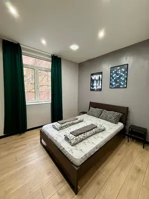 a bedroom with a bed and a large window at The Rainbow 10 in Sofia