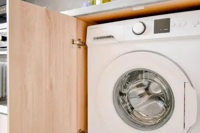 a white washing machine in a cabinet in a kitchen at Orchidea City Centre 1BDR by Flat Mаnager in Sofia