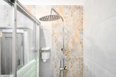 a bathroom with a shower with a glass door at Orchidea City Centre 1BDR by Flat Mаnager in Sofia
