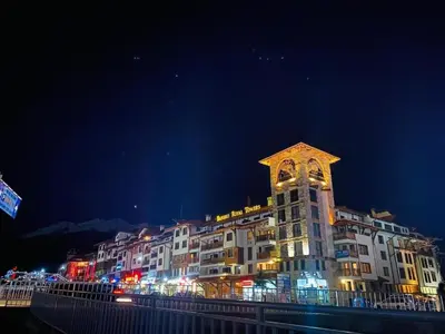 a large building with a clock tower at night at Bansko Royal Towers in Bansko