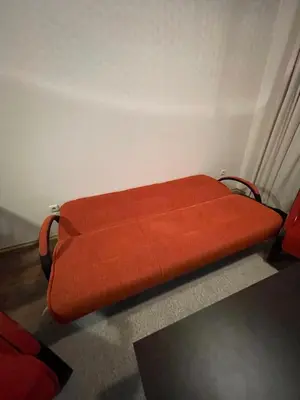 a red bed sitting in a corner of a room at Bansko Royal Towers in Bansko