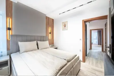 a bedroom with a large white bed in a room at Апартхотел Сенатор Пловдив Self check-in in Plovdiv